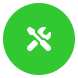 Ein grüner Kreis mit einem weißen Symbol eines Schraubenschlüssels und eines Schraubenziehers, die sich in der Mitte kreuzen, symbolisiert Werkzeuge oder Einstellungen.